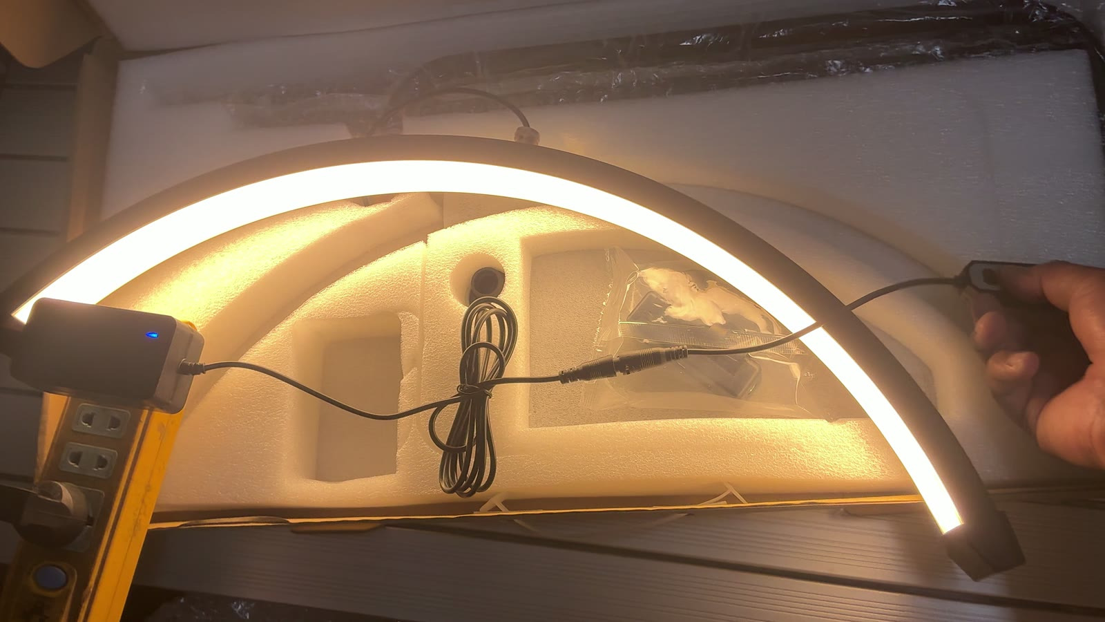 Half-moon LED beauty lamp switched on during inspection in Yiwu, running through its colour temperature settings