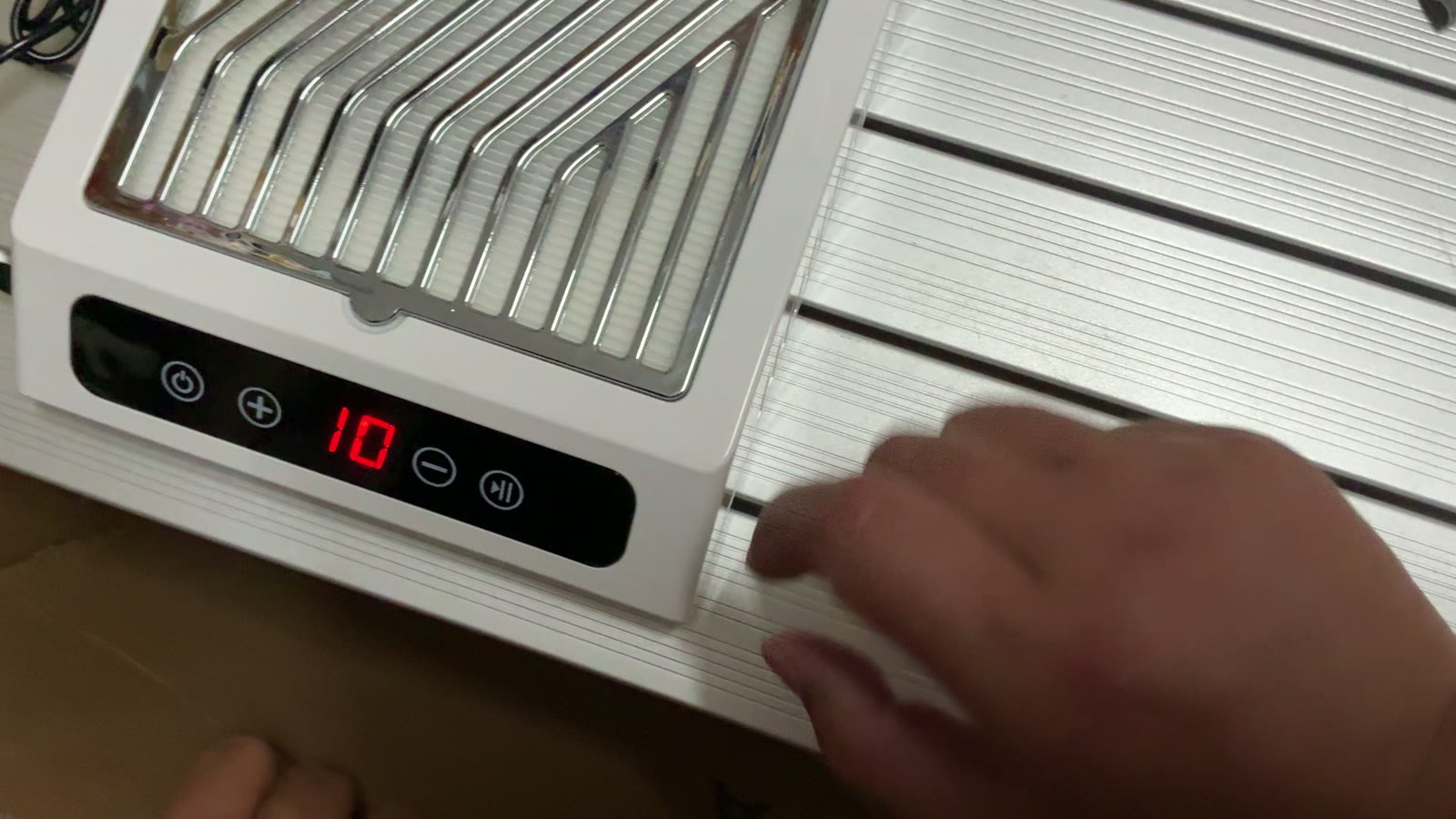 Nail dust collector powered on during inspection in Yiwu, speed setting shown on its display