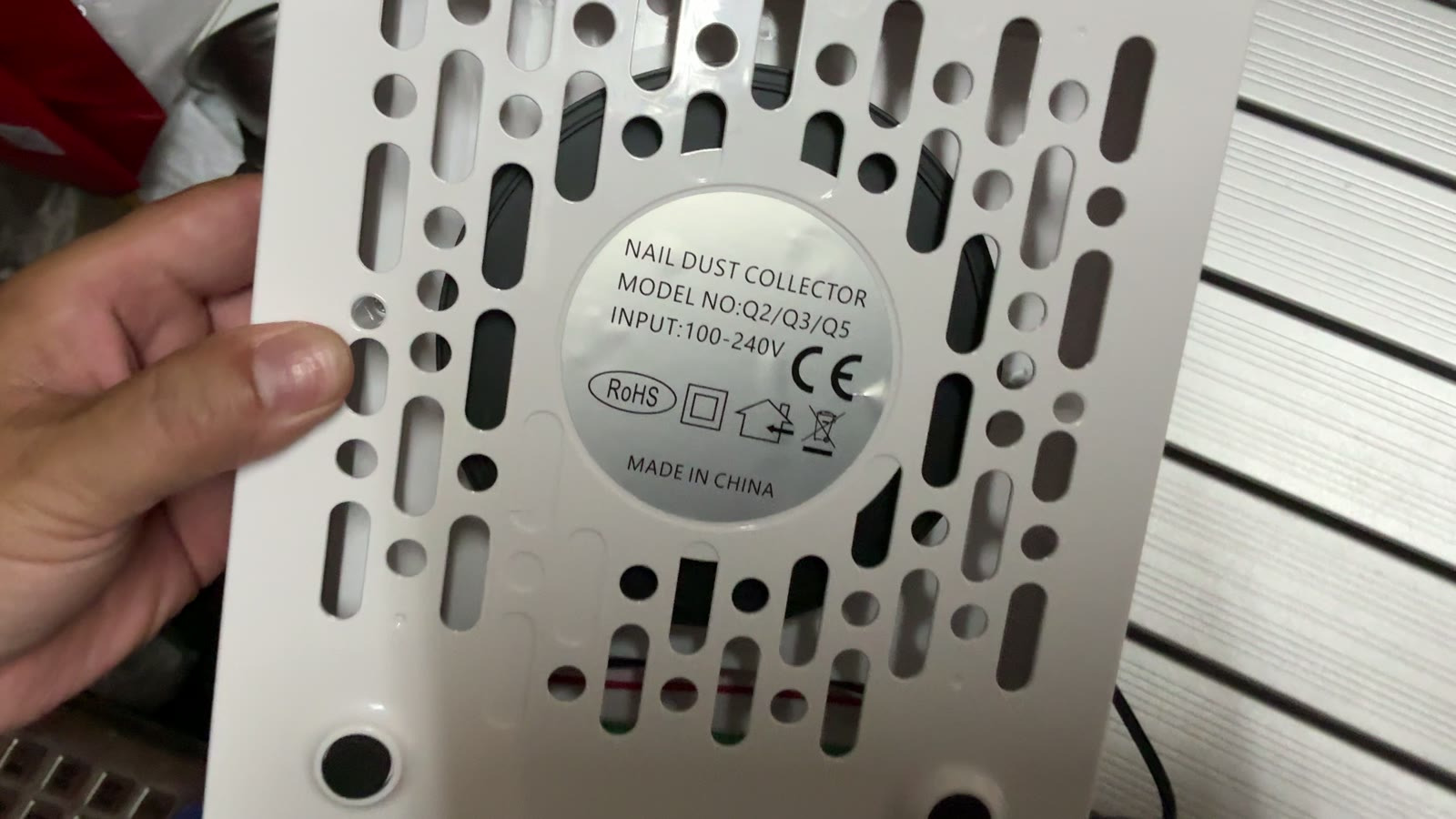 Close-up of the rating plate on a nail dust collector checked during inspection in Yiwu, showing model and 100-240V input