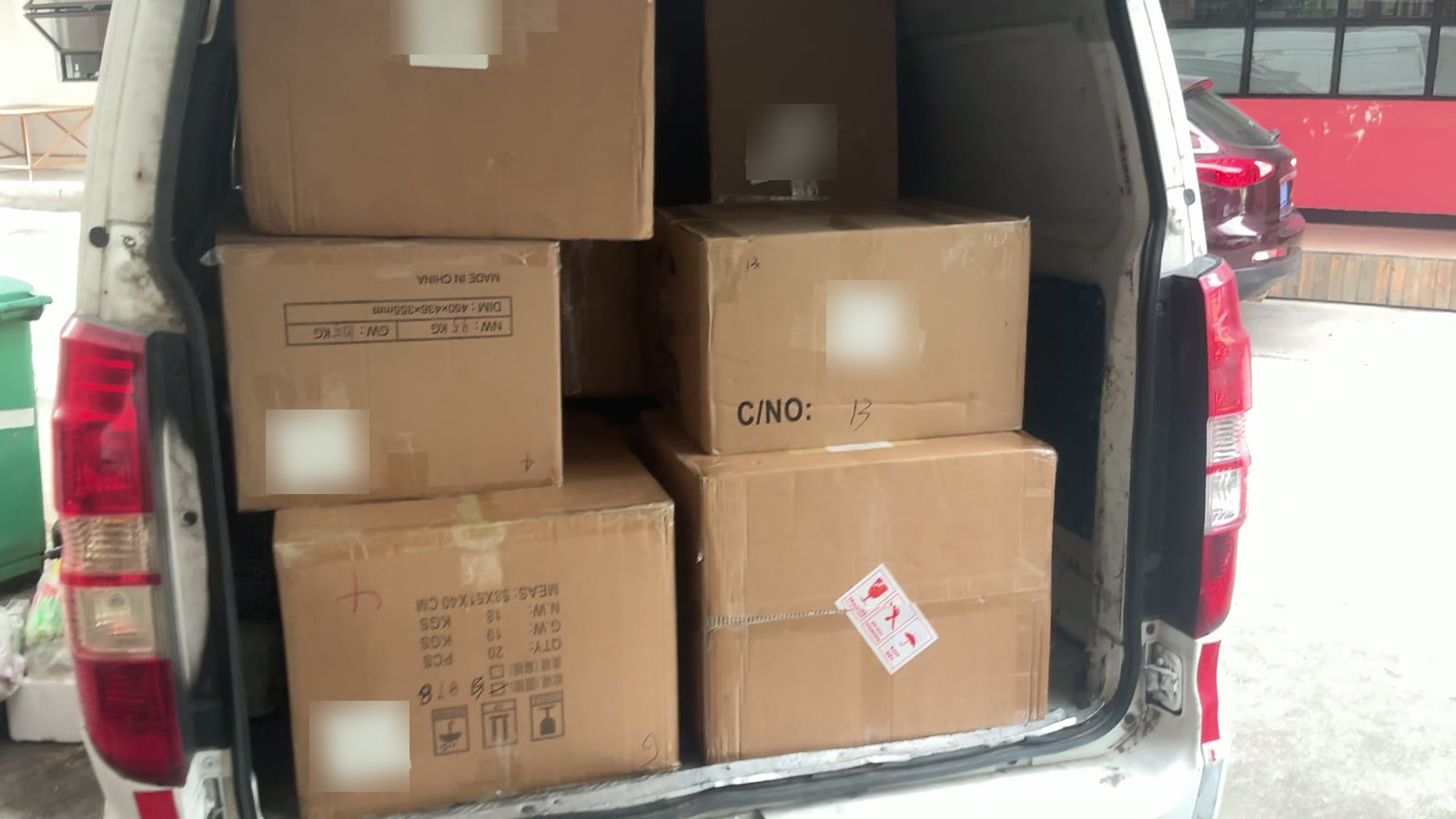 Consolidated cartons loaded for collection in Yiwu, carton numbers and weights stencilled on the boxes